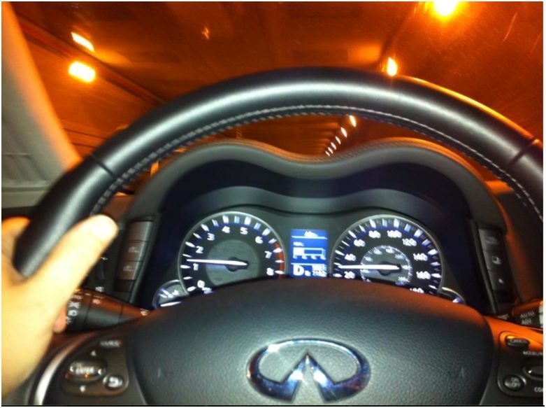View behind the wheel of an Infiniti M56 in the Midtown Tunnel