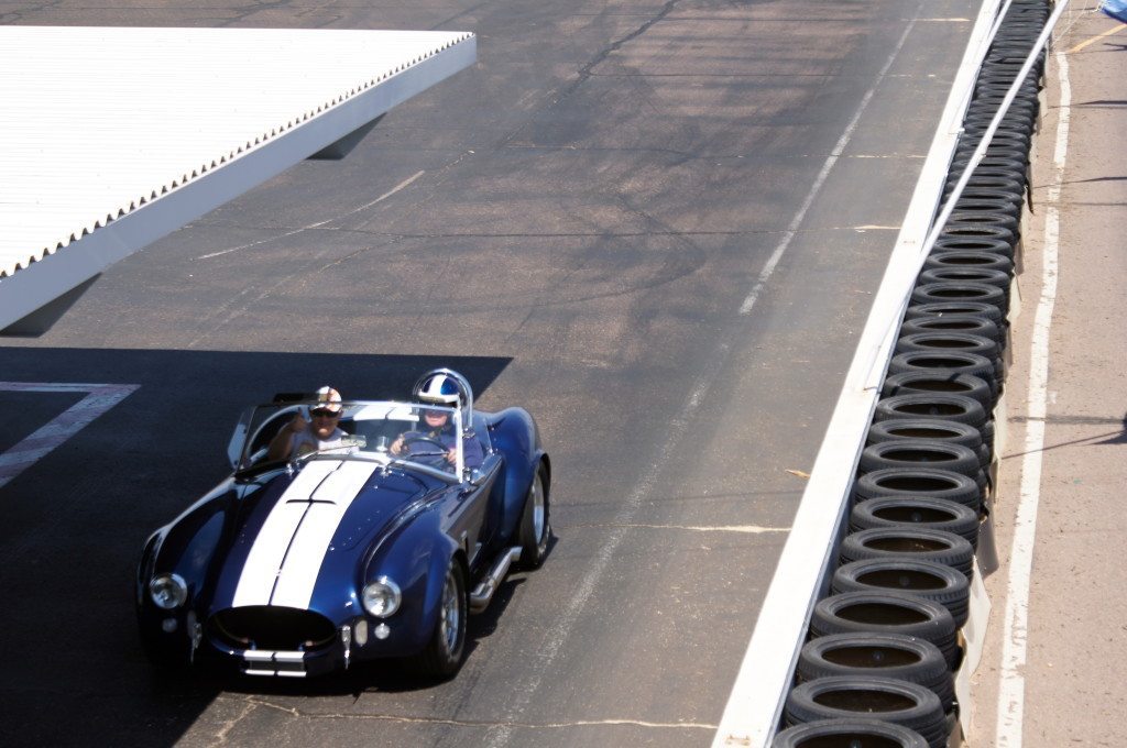 Ryan Schnell gets the ride of a lifetime as Bob Bondurant take him for a lap in a 550hp Shelby Super Performance Cobra with a supercharged, 427 cubic inch Ford V8 under the hood.