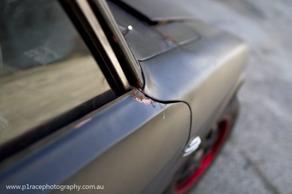 Car heaven - Rusty black Datsun 240Z - front three-quarter panel shot 2