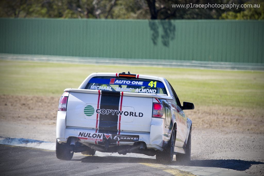 V8 Supercars 2013 - Sandown 500 - V8 Utes - John Wood - VE Holden Commodore SS - Turn 1 overshoot - rear shot 5