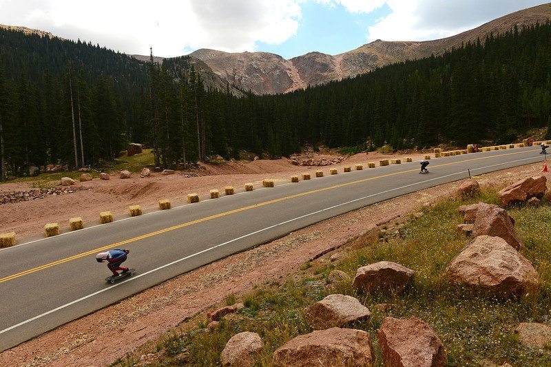 A rider races down the 1.4-mile course with Pikes Peak as a backdrop during the International Pikes Peak Longboarding Competition on Pikes Peak outside of Colorado Springs, CO on September 8, 2013. Photo by Helen H. Richardson/The Denver Post