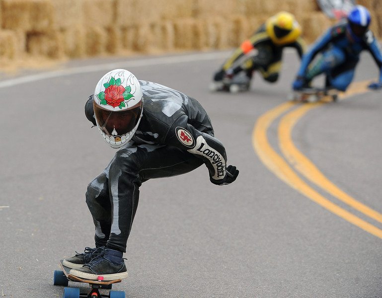 Billy Bones makes a fast descent as he races down the 1.4-mile course on Pikes Peak outside of Colorado Springs, CO, on September 8, 2013 during the International Pikes Peak Downhill Longboarding Competition. Photo by Helen H. Richardson/The Denver Post