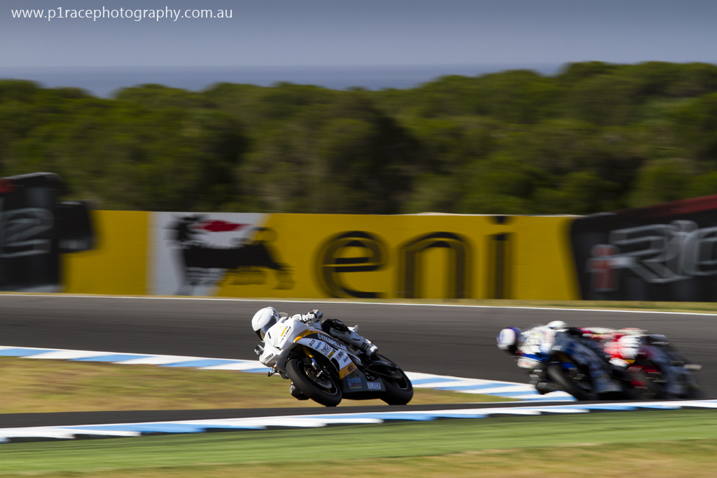 WSBK 2014 - Round 1 - Phillip Island - Sunday - Australian Supersport Race 2 - Daniel Falzon - Caterpillar EPS Yamaha R6 - Leading field - Turn 10 exit - front three-quarter pan 1