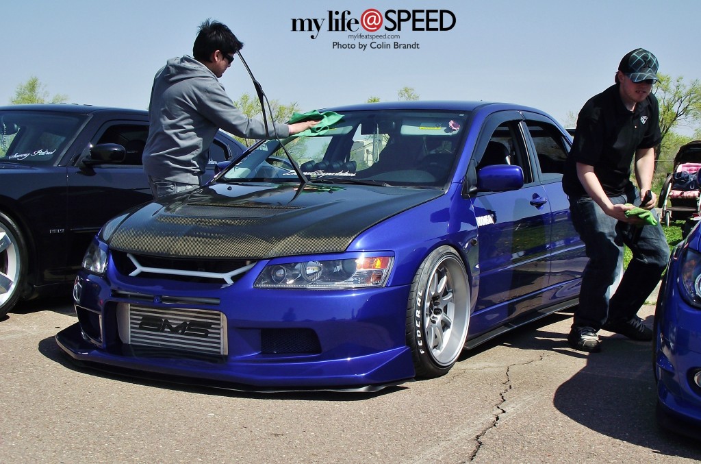 A Mitsubishi Evolution getting some love from its owner. 
