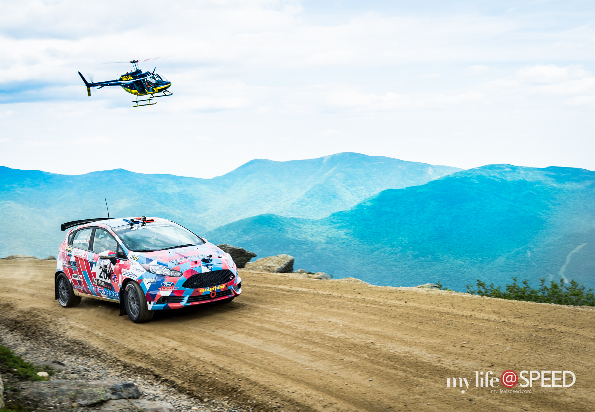 Team Oniel's Andrew Comrie-Picard/Ole Holter 2014 Ford Fiesta shadowed by the Helicopter
