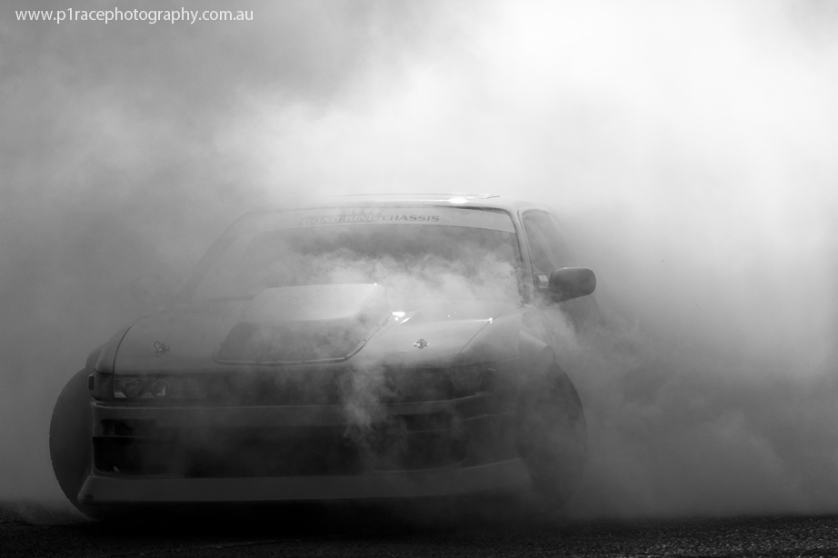VicDrift 2014 - Round 5 - Moe El-Haouli - V8 S13 Nissan Silvia - Post-ceremony burnouts - Front three-quarter B&W shot 1