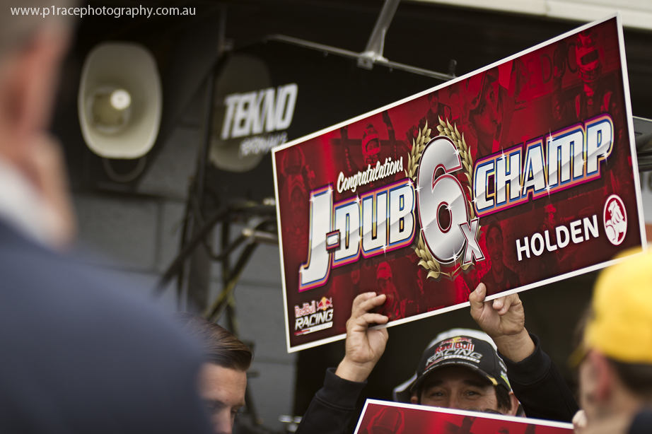 V8 Supercars 2014 - Phillip Island 400 - Pits - Post-race - Red Bull Racing Australia crew member holding up congratulatory sign 1