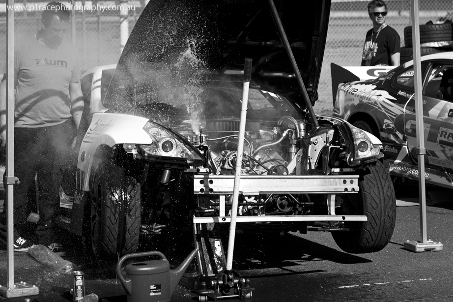 ADGP 2014-15 - Round 2 - Melbourne - Pits - Rob Whyte - MOPAR engine Nissan 370Z - Front three-quarter shot - fluid spewing from catch tank 1