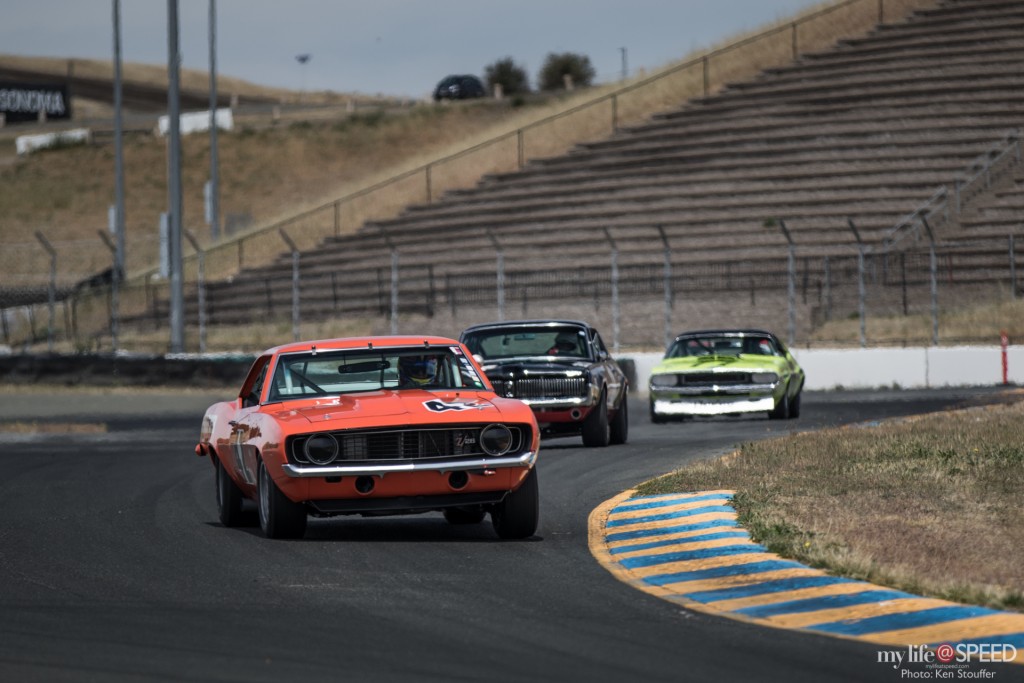 A trio of American Muscle coming out of turn 7