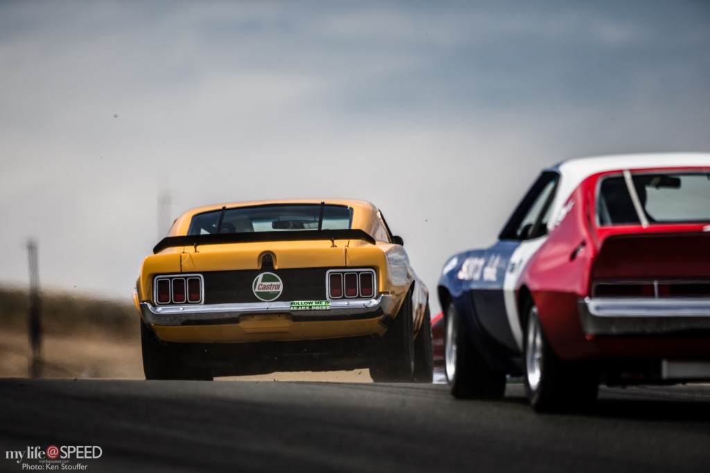 Jim Hague in the 1971 Boss 302 leads Bruce Canepa in the 1970 AMC Jevelin over the crest through turn three
